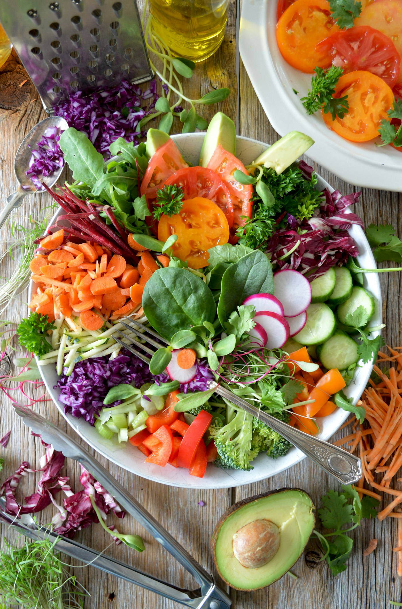 A large platter of crisp raw vegetables, leafy greens and fresh herbs
